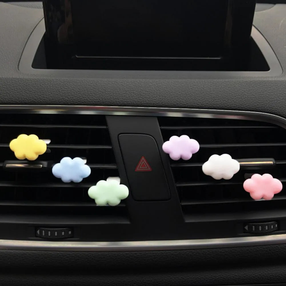 Resin cartoon car fragrance clip in light green colour, dimensions 17mm by 27mm, on a car air vent