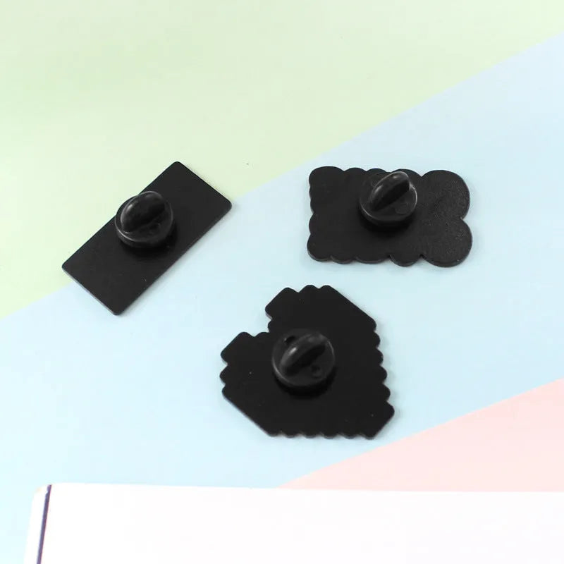 Three-dimensional alloy game console badge in metallic finish with mounting points