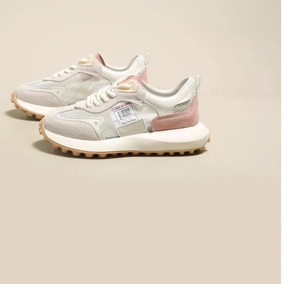 Women's grey and pink low-top retro sneaker with round toe and flat rubber sole.