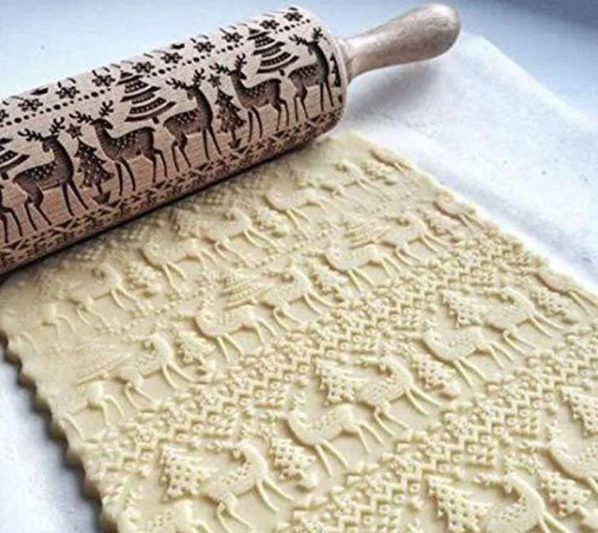 Solid wood rolling pin with embossed Christmas reindeer pattern on a 45cm long shaft.
