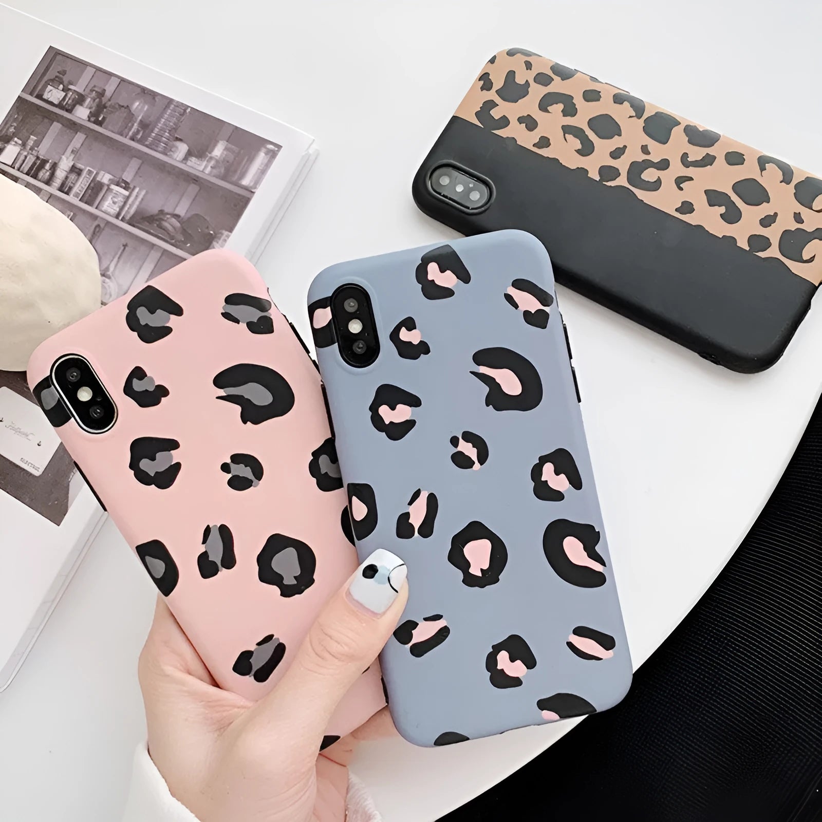 Leopard print pattern phone case for iPhone shown in black, blue, and pink colour options.