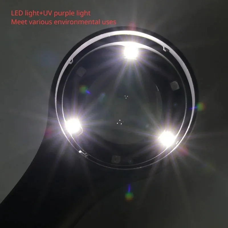 Black and silver jewellery appraisal magnifying glass with optical glass lens and USB-C cable on a table.