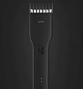Black and white cordless hair clippers with adjustable comb, nano-ceramic cutter head, and two-speed control for precise haircuts