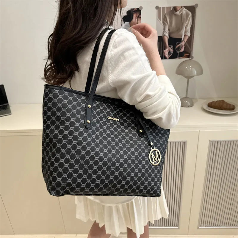 PU street style shoulder bag in black showing 42cm width and sewing thread detailing with polyester lining
