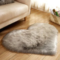 Plush heart-shaped carpet with 5-6 cm pile in navy blue colour on wooden floor