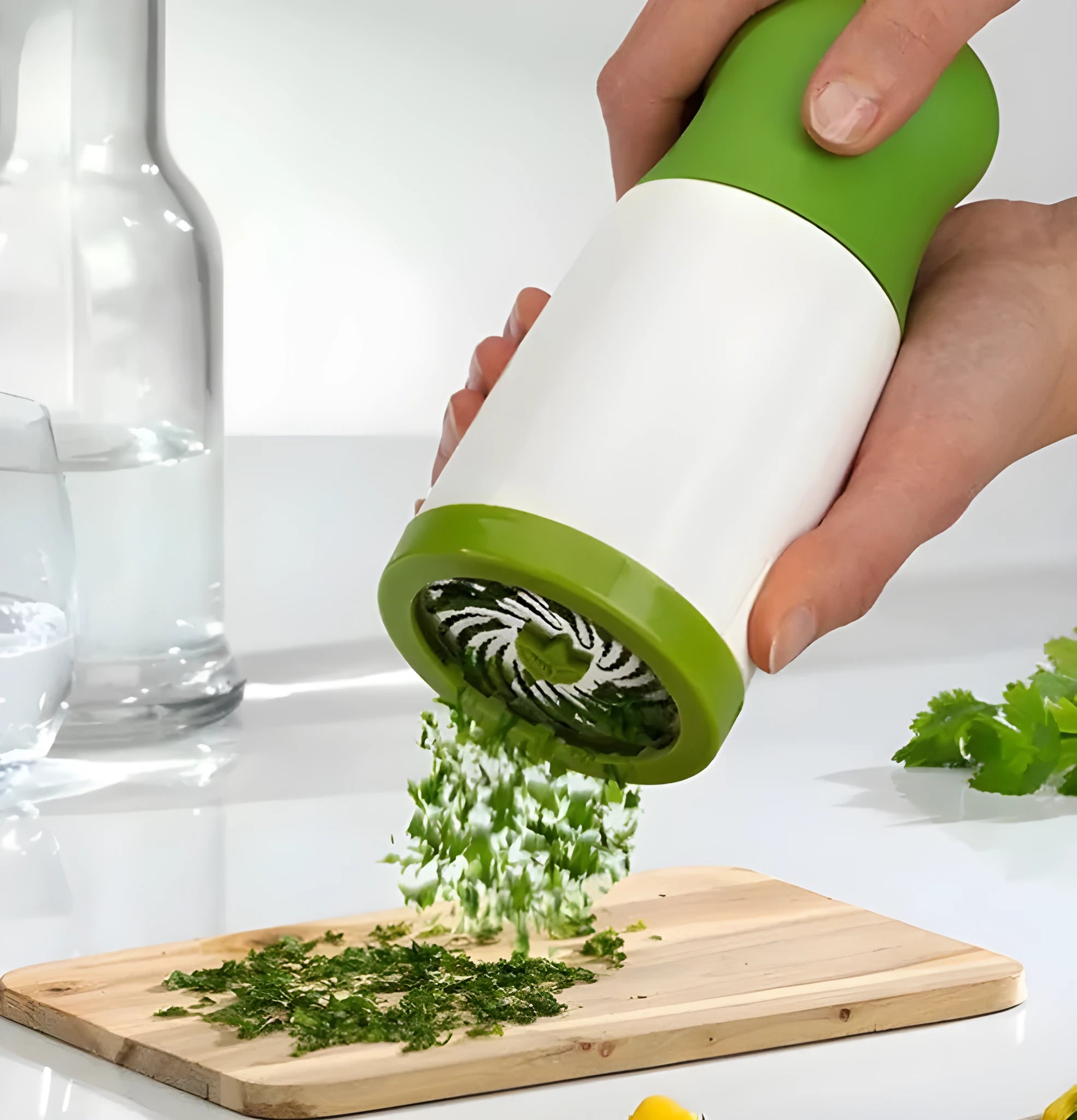 White and grey manual herb grinder with a removable top, showing stainless steel blades inside.