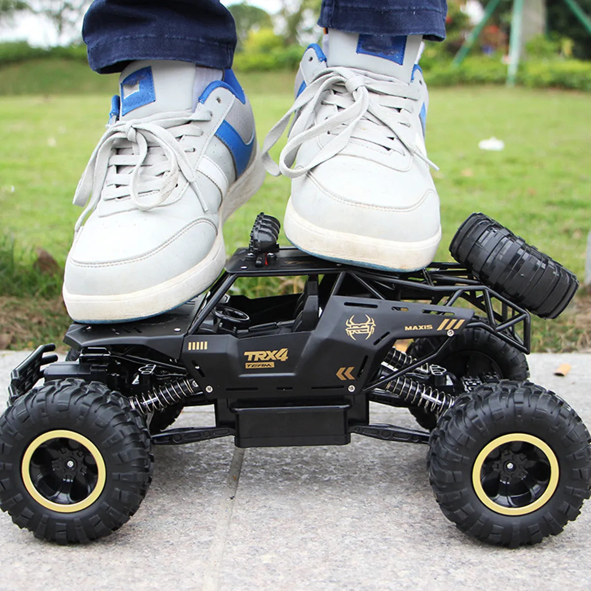 Black or silver remote control climbing car with 2.4G wireless remote on rough terrain