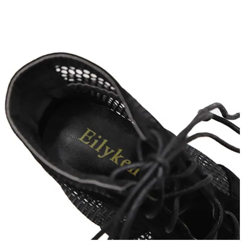 Black suede lace-up high heel women's shoes with 11.5cm heel and 1cm platform, showing adjustable laces and textured surface