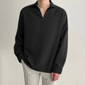 Men's loose fit long sleeve casual business shirt in a solid colour on a hanger