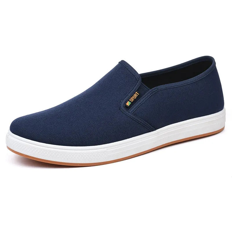 Men's low-top canvas slip-on shoes with round toe and injection moulded soles in black or blue