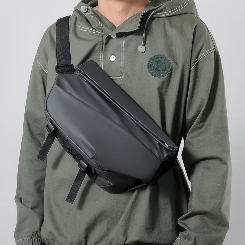Men's grey crossbody bag with motorcycle sling strap, horizontal square shape, and zipper opening