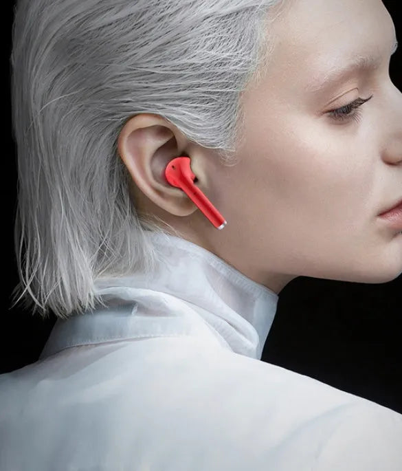 Lipstick-shaped Bluetooth earphones in black with compact charging case, showing in-ear design for noise reduction
