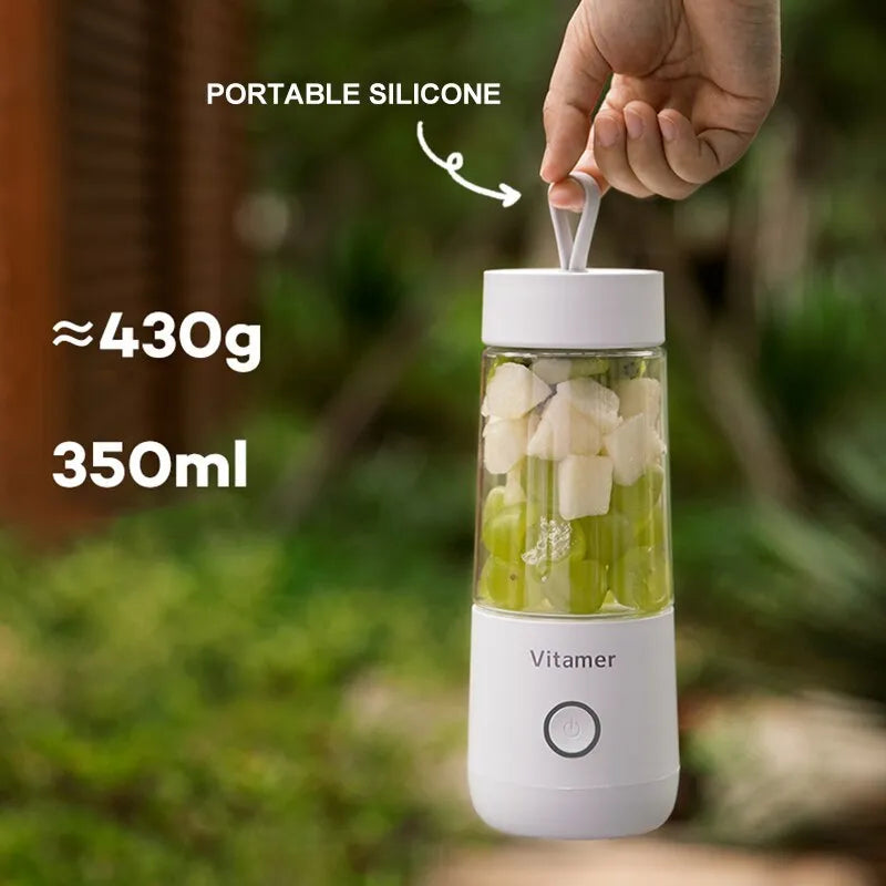 White portable USB rechargeable blender with 350ml cup and silicone handle on a table.