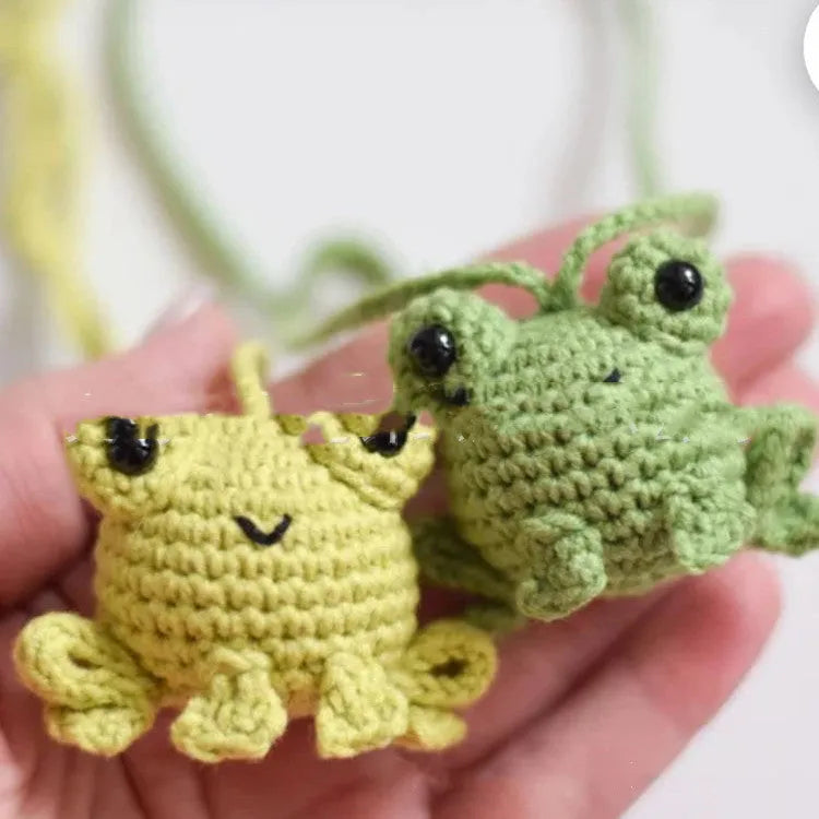 Handmade woven car pendant with small frog design, plush material, 5cm by 5cm by 15cm dimensions, available in four colours.