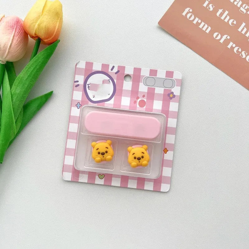 Cartoon-style magnetic plastic cable fixer clip in various colours on a metallic desk surface.