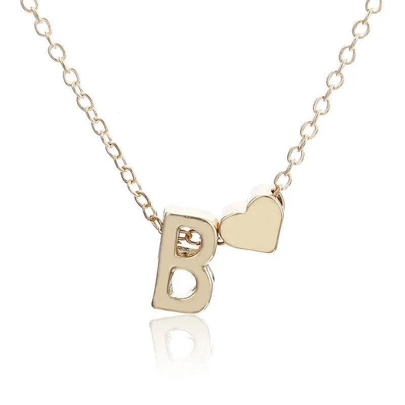 Peach heart shaped letter necklace pendant in gold or silver alloy, weighing 5.5g.