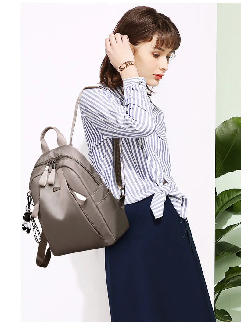 Women's Oxford cloth backpack in black, large capacity anti-theft travel bag with zipper closure and soft handle