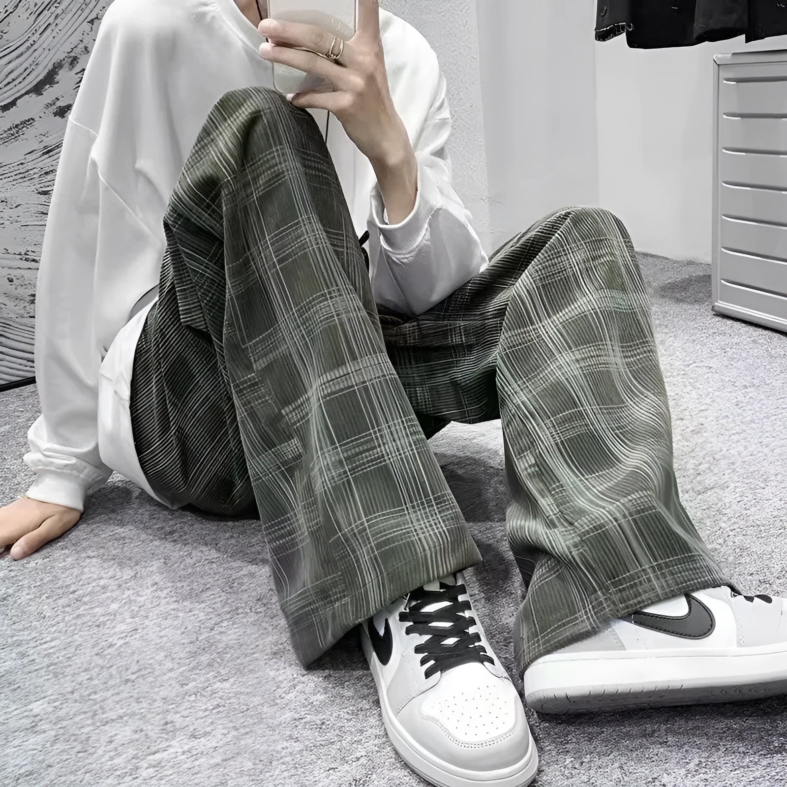 Men's black and green plaid trousers with straight leg design and mid-rise waistband