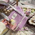 Wool crocheted bear shoulder bag with wooden handle showing crochet texture detail
