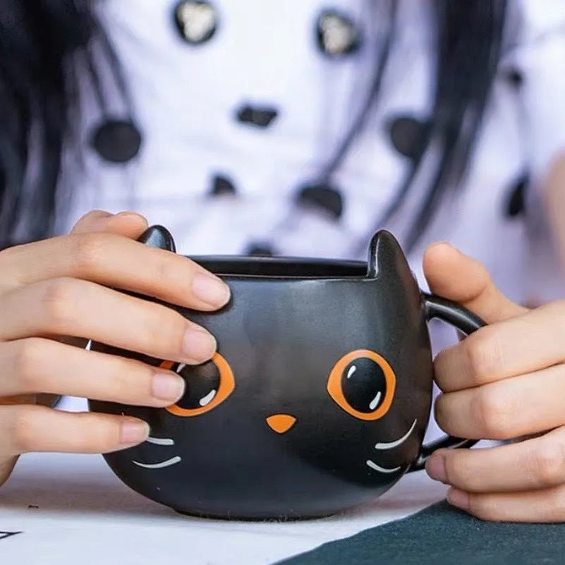Black ceramic novelty mug with Halloween pumpkin, spoon couple, and cat design, 355ml capacity.