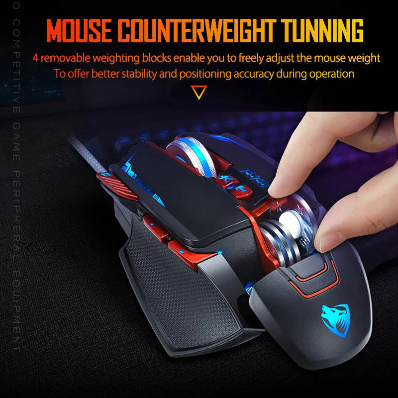 Black Thunder Wolf V9 wired gaming mouse with six buttons on a desk next to a keyboard.