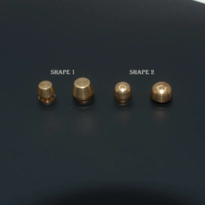 Brass decorative buckle for footwear showing 10x6mm and 12x7mm sizes in round and geometric shapes