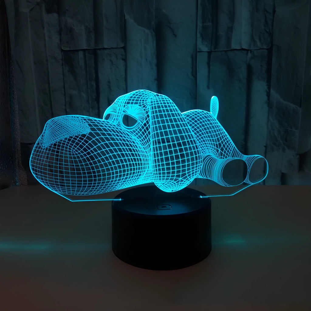 Doggo shaped 3D illusion desktop lamp glowing in multiple colours on a desk.