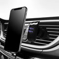 Black car phone holder attached to vehicle air vent with smartphone securely mounted