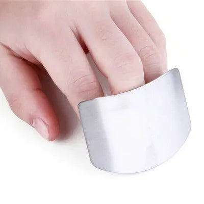 Stainless steel finger guard for kitchen safety shown in single and double finger sizes on a cutting board.