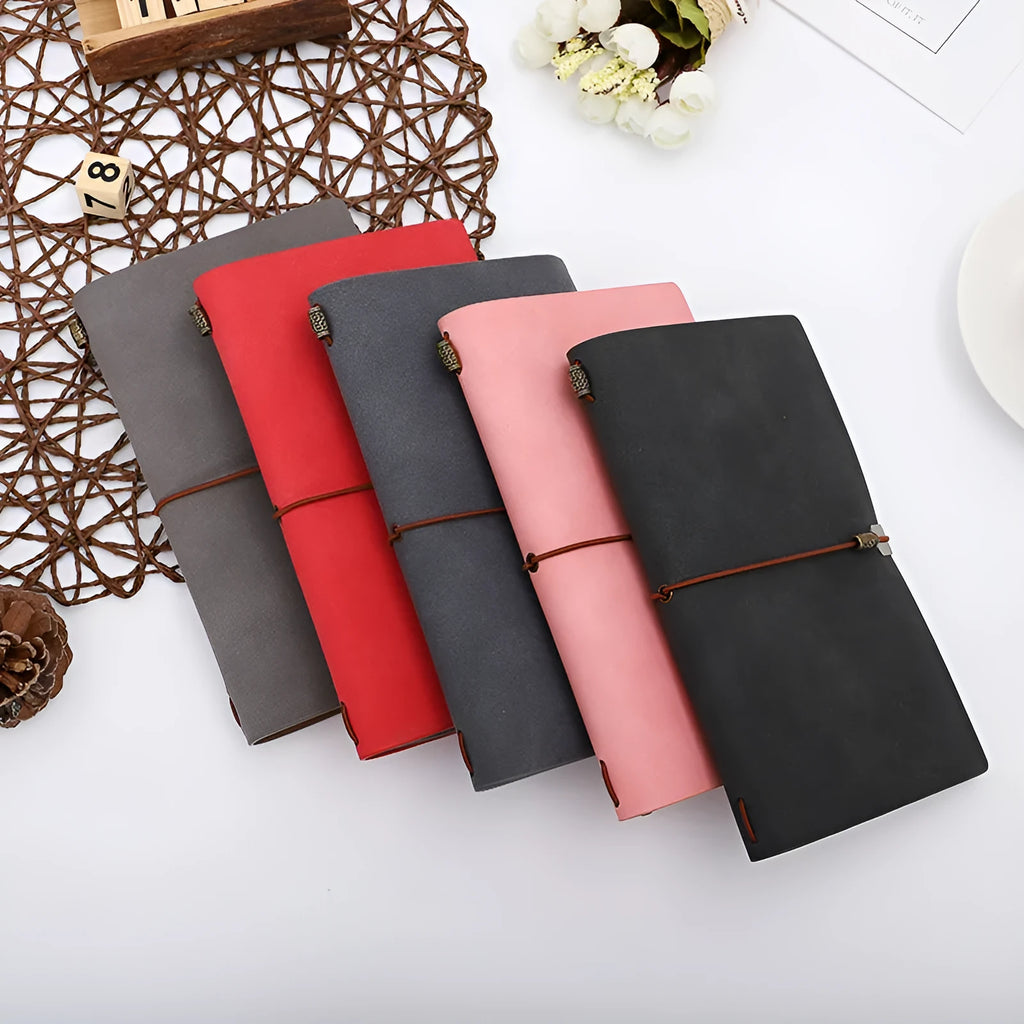 A6 notebook with imitation leather cover in choice of grey, pink, or red, showing cowhide rope style binding.