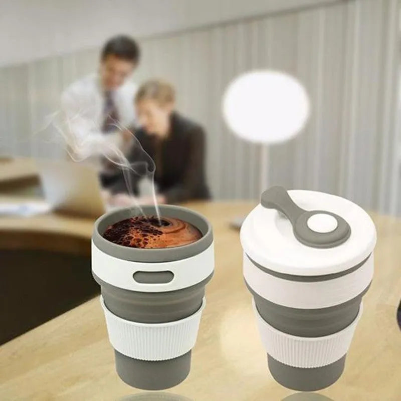 Green collapsible silicone travel cup folded to 6cm height next to expanded 350ml version with leak-proof cover