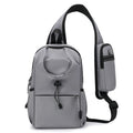 Dark grey Oxford cloth crossbody chest bag with stitching detail, shown being worn.