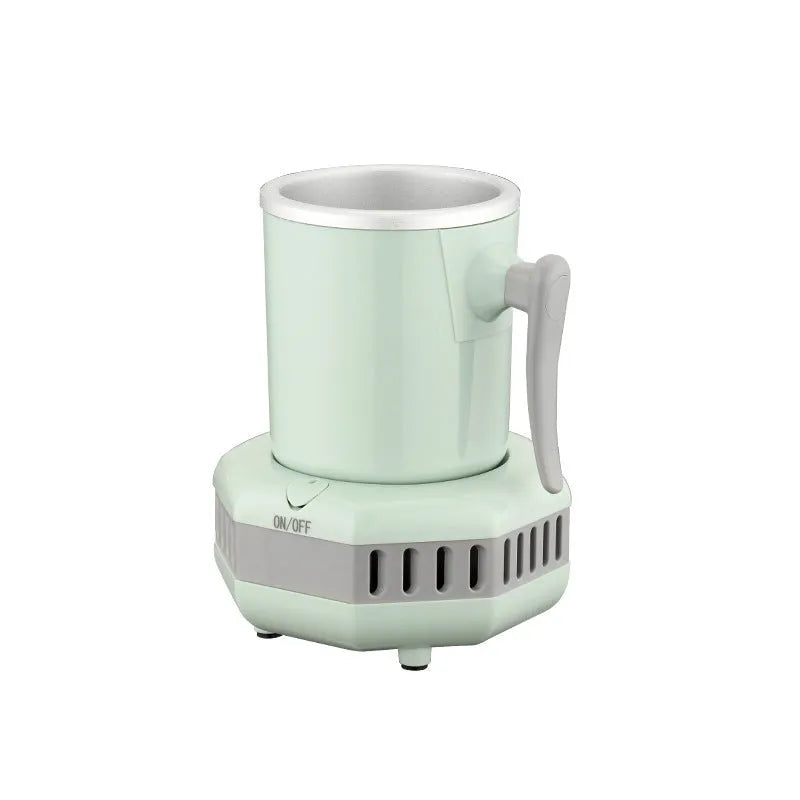 White portable aluminium quick-cooling cup and base on a desk next to a coffee mug.