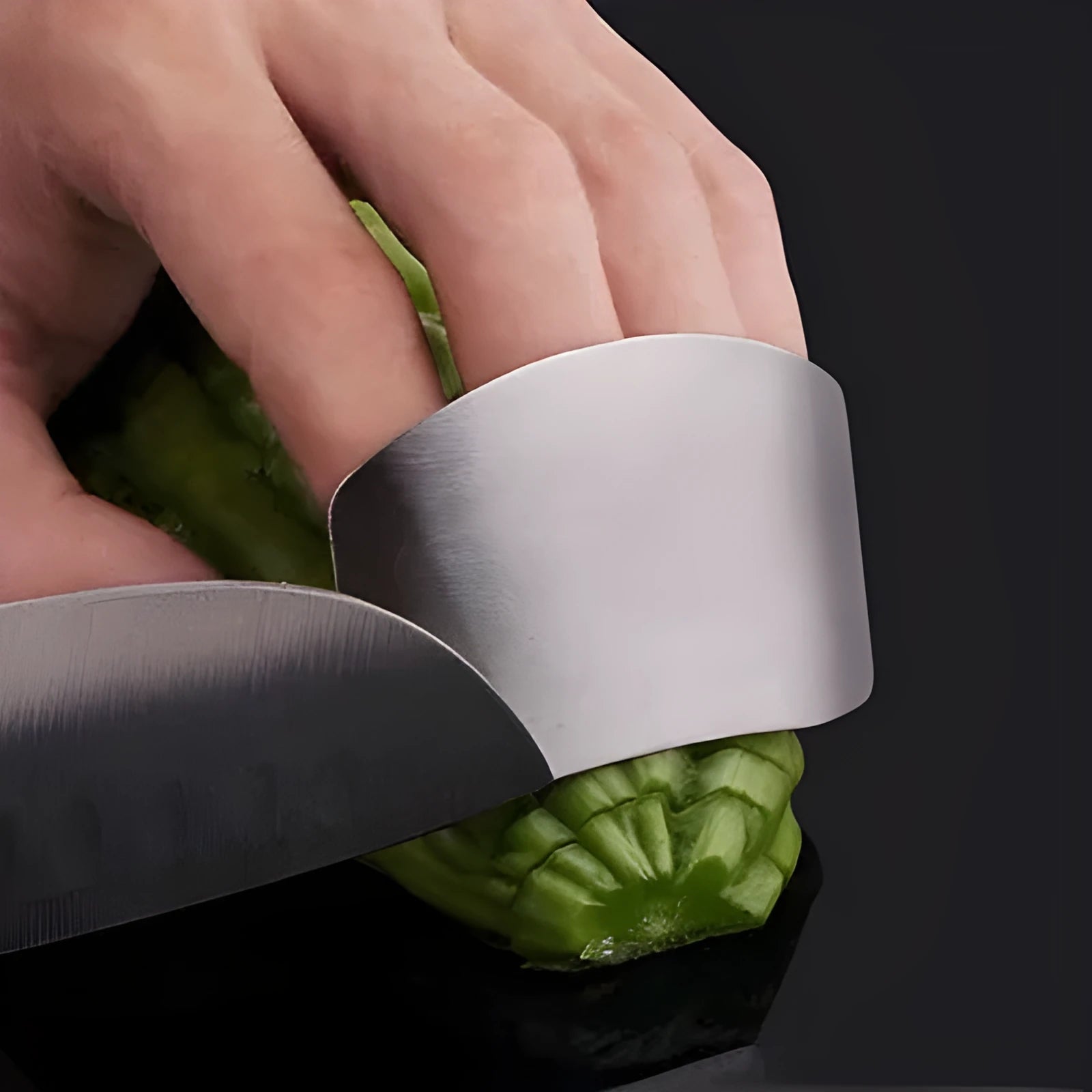 Stainless steel finger guard for kitchen safety shown in single and double finger sizes on a cutting board.