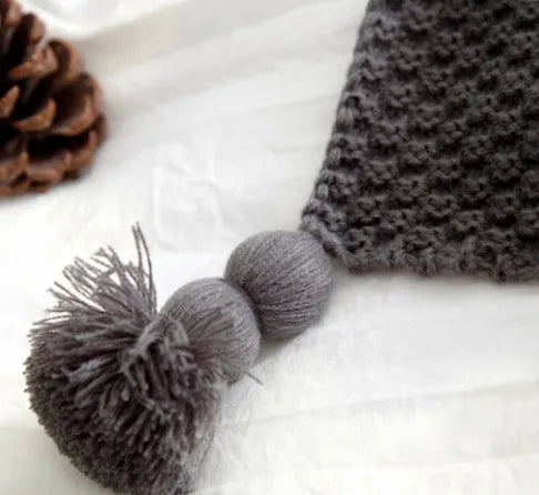 Nordic style acrylic knit blanket with ball fringe, shown in beige, dimensions 130 by 170 cm.