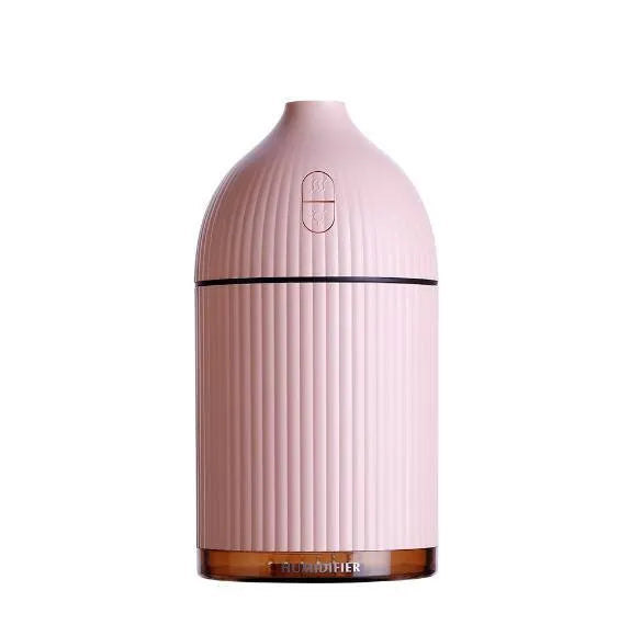 White ultrasonic aromatherapy diffuser with LED light, 300ml capacity, and USB cable on a wooden table