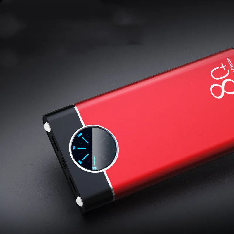 Black fast charging 20000mAh power bank with alloy shell and LED flashlight on a table.