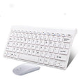 Black wireless keyboard and mouse set with USB receiver on wooden desk