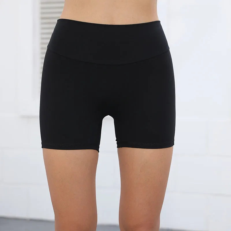 Women's high waist hip lifting shorts in avocado green with side pockets during yoga pose