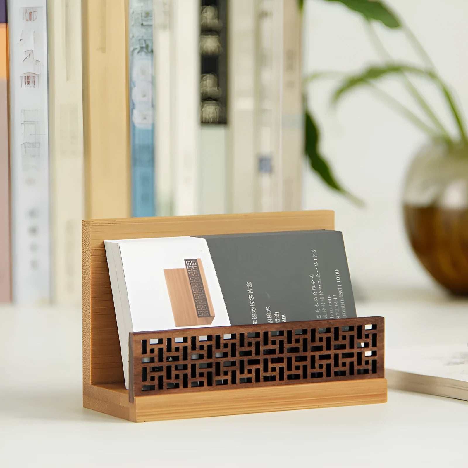 Geometric bamboo business card holder on a desk, showing natural wood grain and card slots.