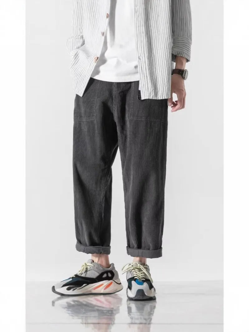 Loose straight tapered pants in dark grey, black, or khaki with wide legs and straight-leg opening