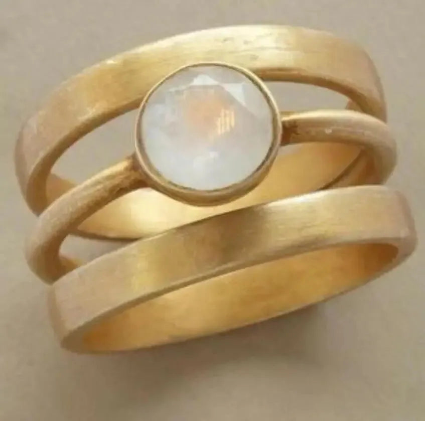 Gold-plated titanium steel ring with white chalcedony stone in geometric hollow band design