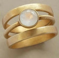 Gold-plated titanium steel ring with white chalcedony stone in geometric hollow band design