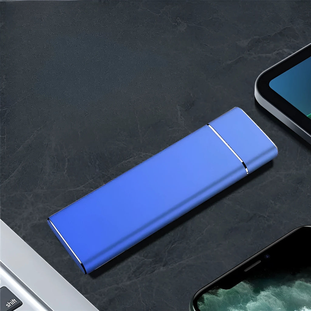 Sapphire blue portable external solid state hard disk drive with metal shell next to a USB cable.