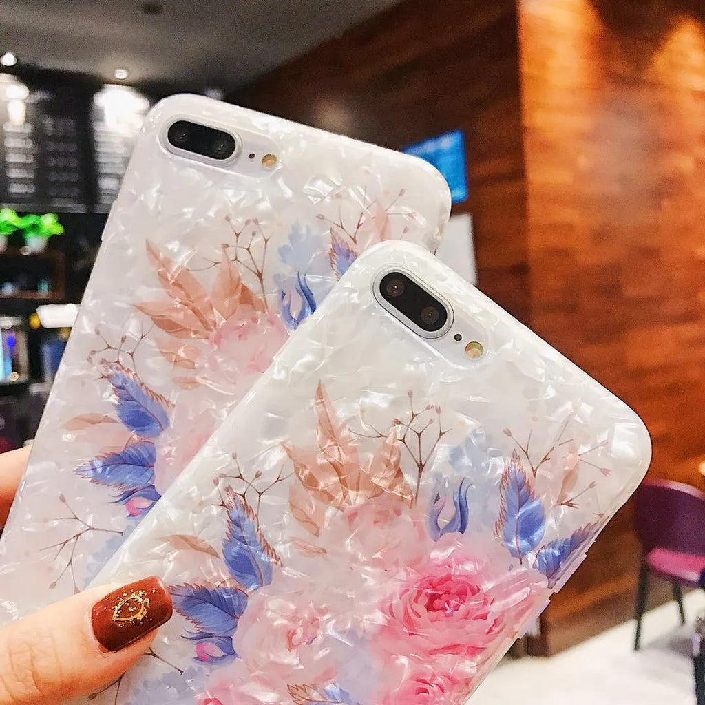 Soft TPU iPhone case with a rose flower design on the back, shown in brown.