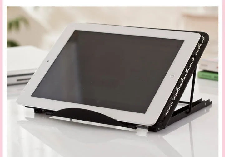 Folded metal laptop stand in silver colour showing slim 1.5cm profile next to a laptop.