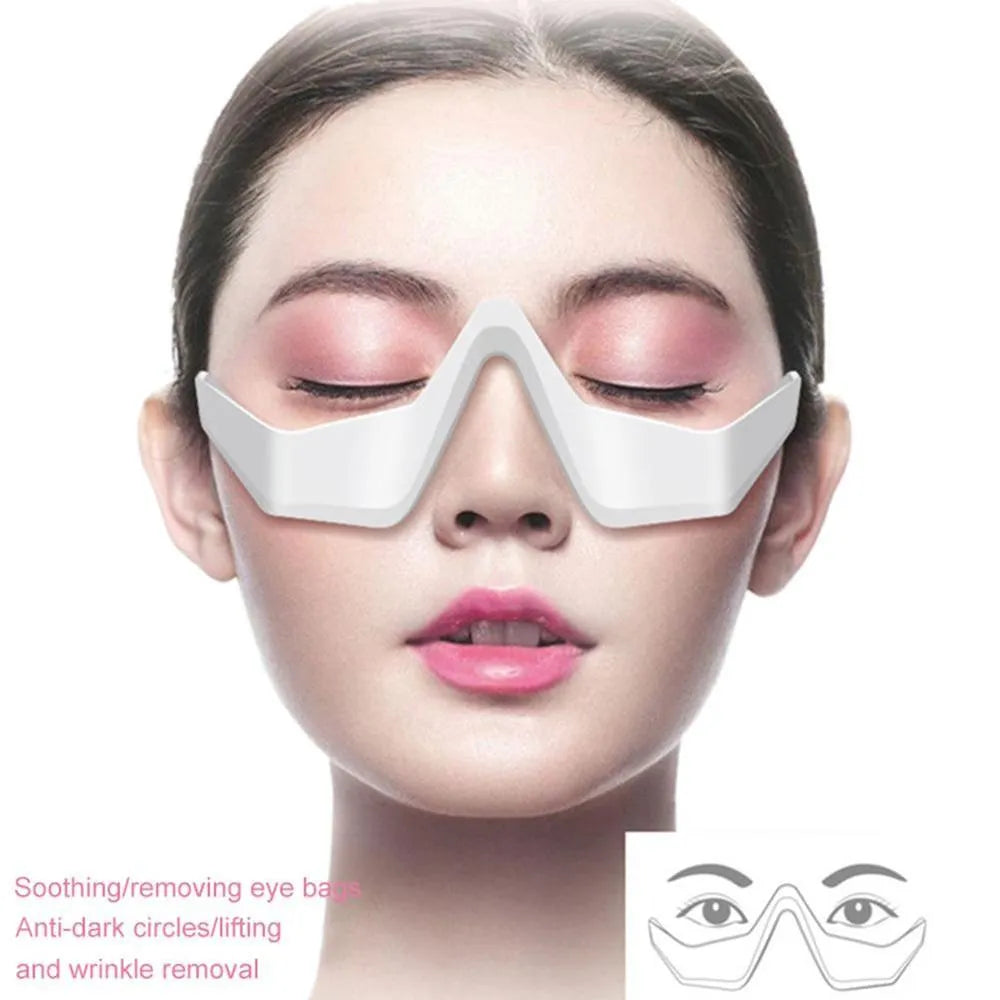 Pink and white USB rechargeable micro-current eye massager with glasses-style frame on a grey background.