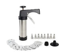 Stainless steel biscuit press gun with assorted cookie moulds and piping nozzles on a baking tray.