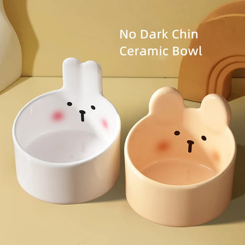 Ceramic pet bowl with neck guard design in white rabbit pattern, shown next to a large brown bear pattern bowl.