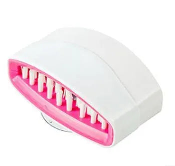Coloured kitchen brush with knife and fork design and a white suction cup on its handle.